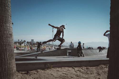 venice beach person jumping on skateboard on park los angeles